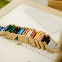 Children in kindergarten put together educational puzzles.