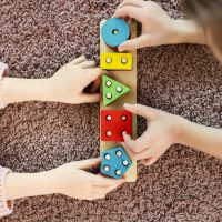 top-view-kids-playing-with-wooden-toy