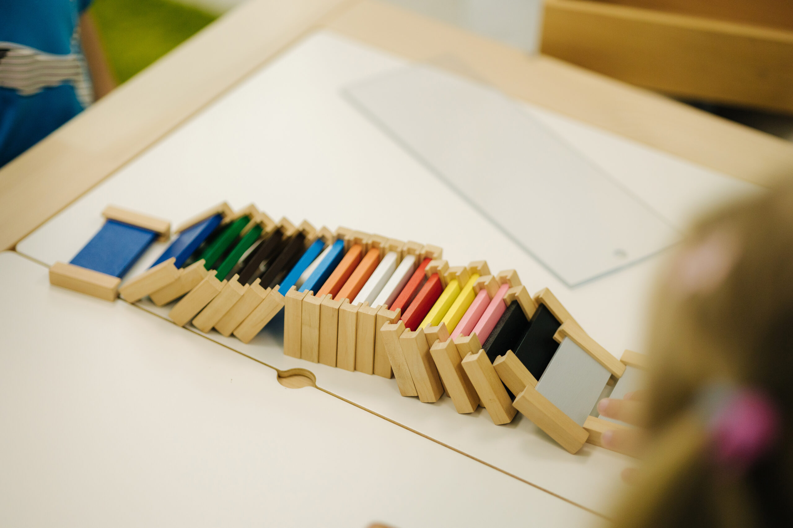 Children in kindergarten put together educational puzzles.