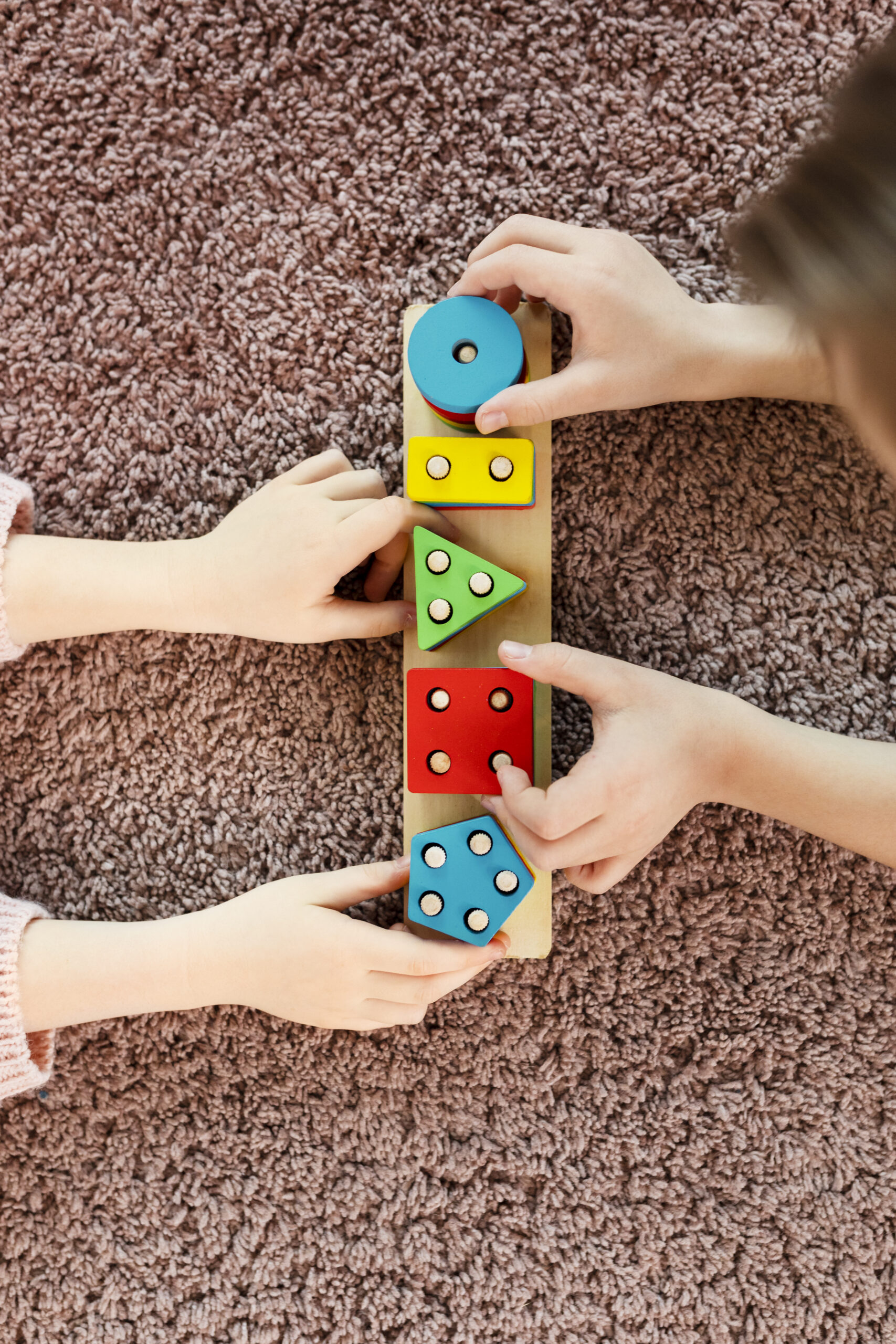top-view-kids-playing-with-wooden-toy